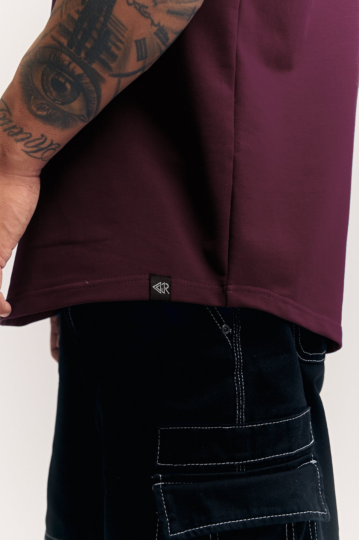 Maroon Eternal relaxed fit polo t-shirt for men, hem and woven label close-up – Rewind Apparel Dubai