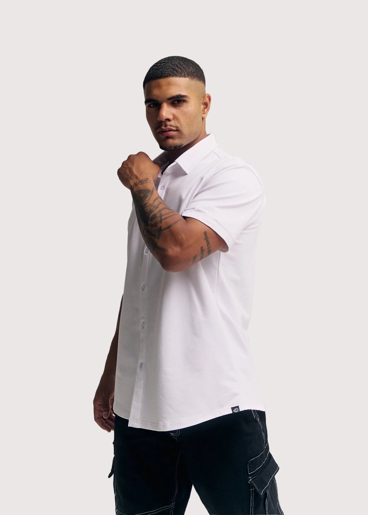 White Prime relaxed fit button-up shirt for men, side view with arm raised – Rewind Apparel Dubai