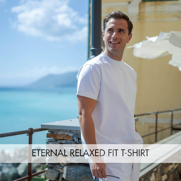 A man wearing an Eternal Relaxed Fit T-shirt near the beach, showcasing a comfortable relaxed fit t-shirt style.