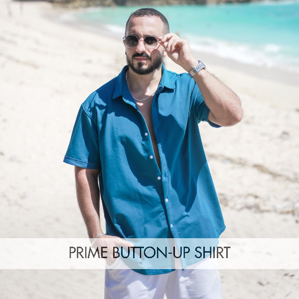 Man wearing a Prime Button-up Shirt on the beach showcasing its style as a men's versatile button-up shirt.