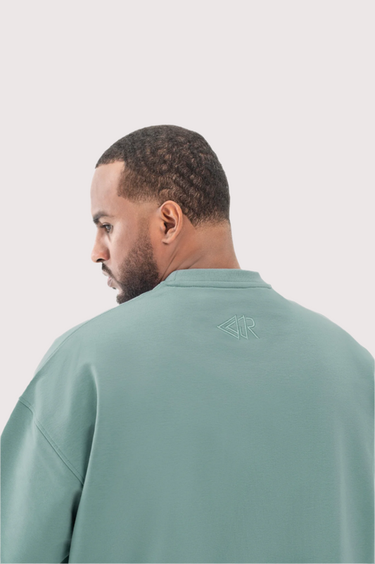 Green Flawless oversized t-shirt for men, embroidered back logo close-up – Rewind Apparel Dubai