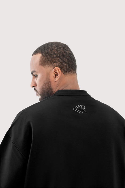 Black Flawless oversized t-shirt for men, embroidered back logo close-up – Rewind Apparel Dubai