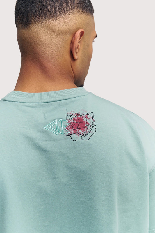 Green Rewind x Koko's Art oversized graphic t-shirt for men, embroidered rose artwork close-up – Rewind Apparel Dubai